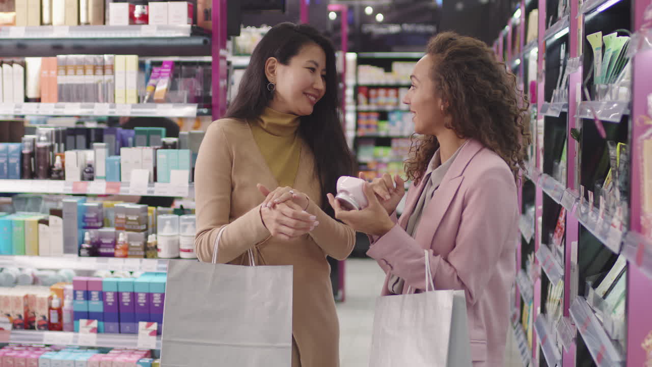 Girlfriends Reading Skin Care Product Ingredients In Shop