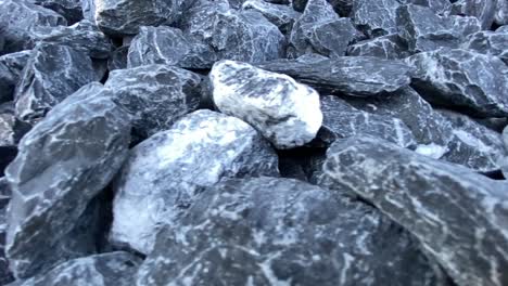 close up shot of several grey chalky granite stones in nature,dolly shot