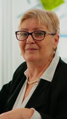vertical video portrait of senior businesswoman looking at camera