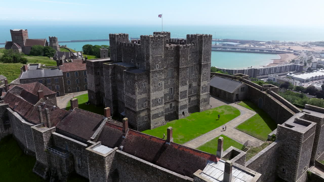 Dover Castle With Roman Lighthouse And St Mary's in Castro Church In The Background In Kent, England, UK. - aerial shot