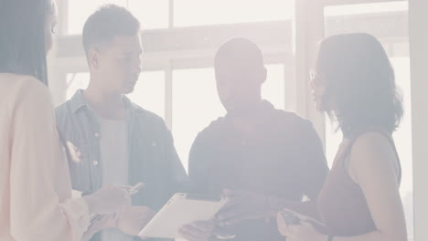 Diverse-group-of-young-businesspeople-discussing