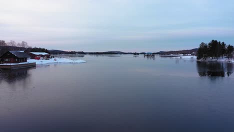 aerial footage flying low over a skim of ice out of the east cove of moosehead lake