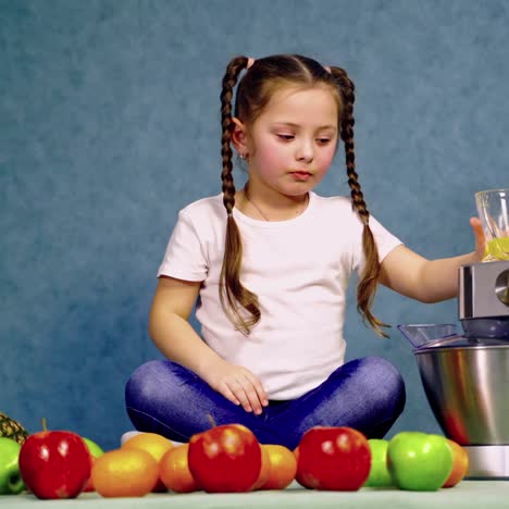 child girl drinking glass of fresh orange juice