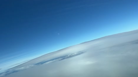 layers of clouds from a jet cockpit during a right turn with the view of the jet halo over the clouds