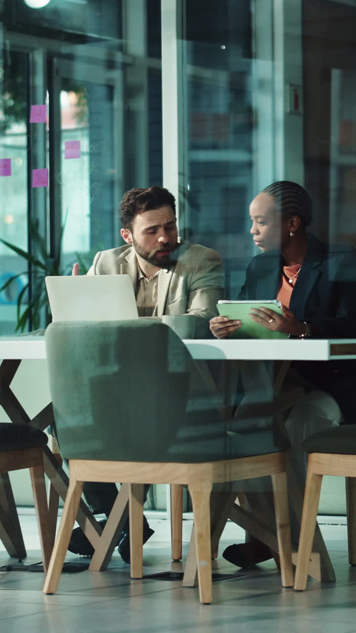 Business Colleagues Collaborating on Laptop and Tablet in Modern Office