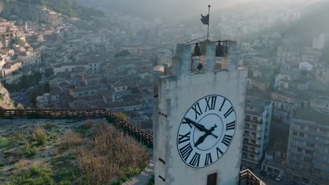 aerial view of modica alta val di noto sicily old baroque town and castle clock tower south italy at sunrise