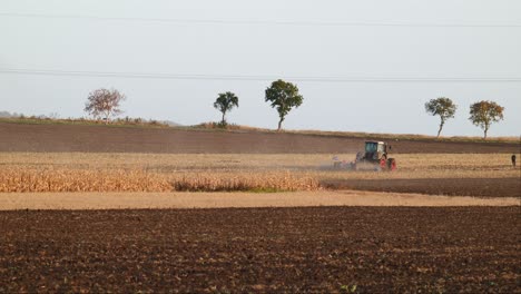 Agricultural-Tractor-Plowing-Golden-Field-In-Autumn-In-Romania