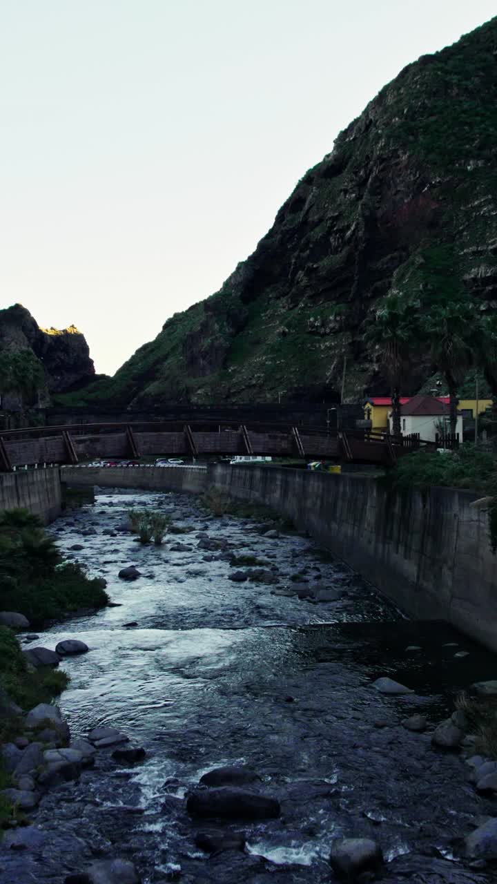 Wooden Bridge Over a Mountain River