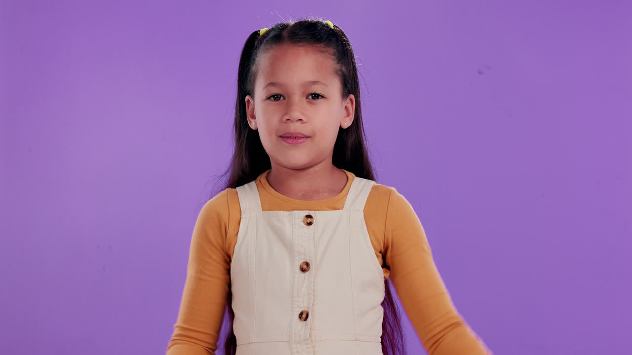 Girl hugging herself on a purple background