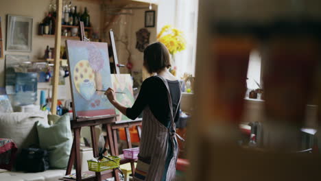 woman artist painting in studio