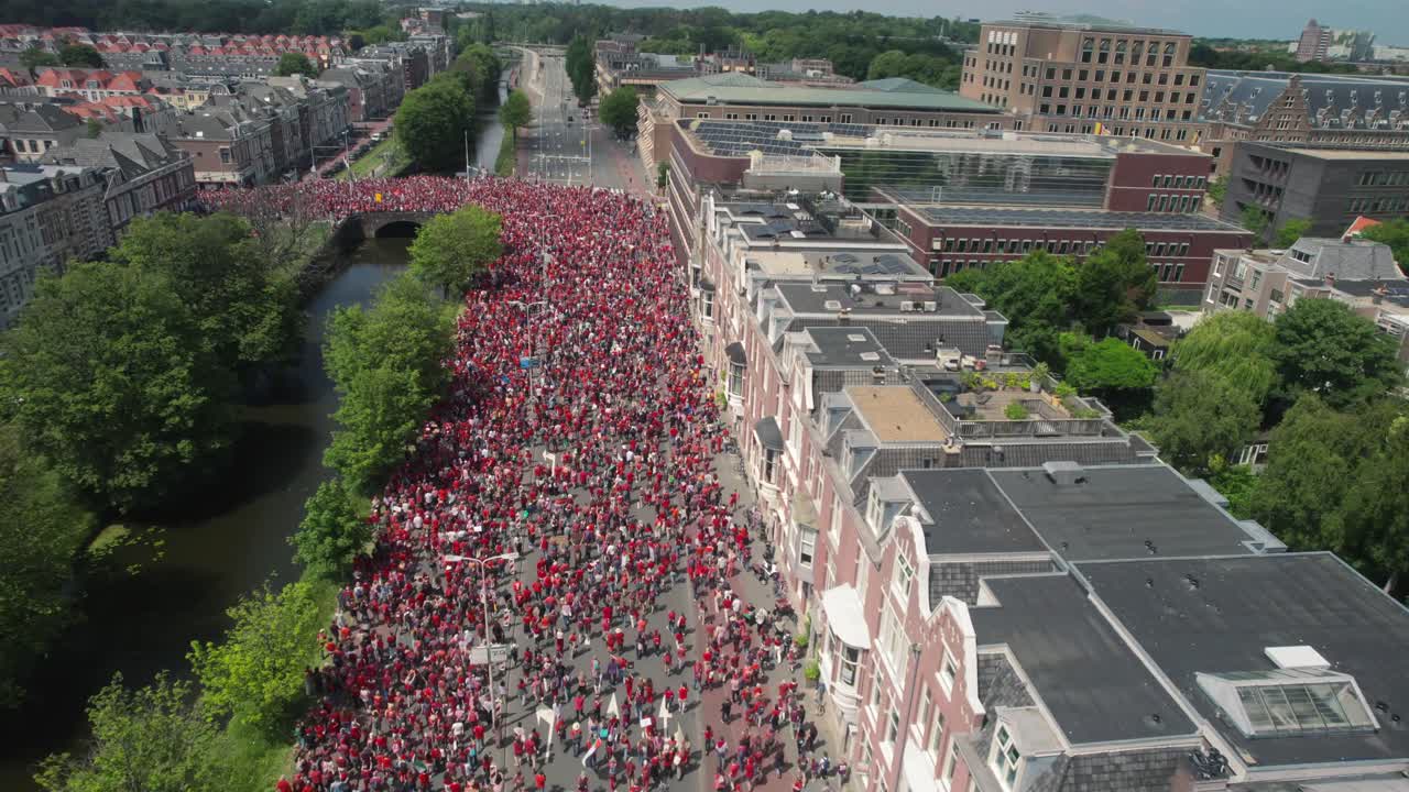 Free Palestine protest Drone aerial shows massive group of people on highway in the Hague, top down view