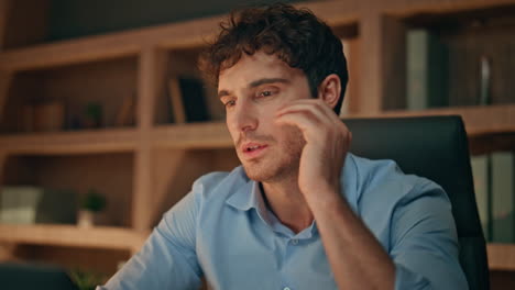 Accountant hands writing notebook at dark workplace close up. Tired man working