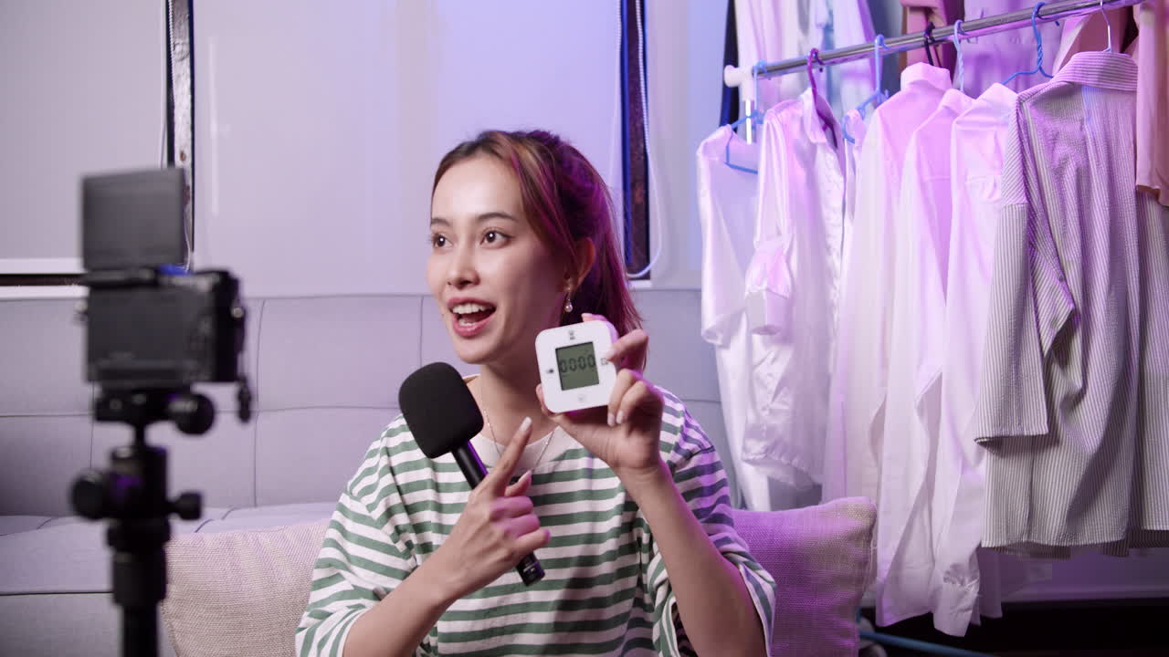 un influencer muestra un dispositivo inteligente compartiendo consejos de vida saludable en un acogedor estudio casero.