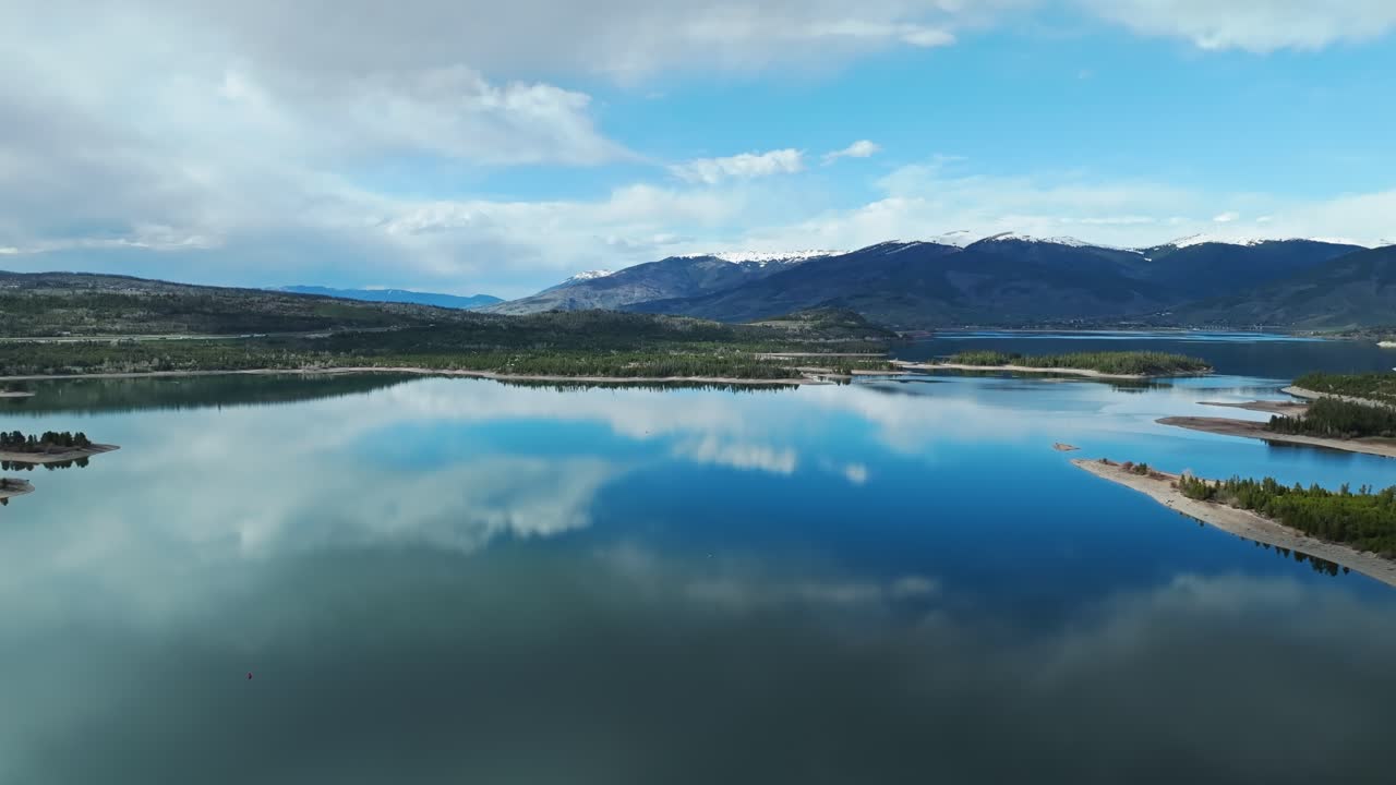 dolly aérea panorámica sobre el embalse pacífico que refleja las nubes y el cielo en frisco colorado
