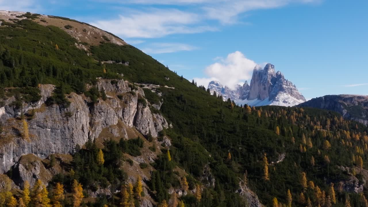 Drone clip of the colourful forest in the Italian Dolomites. The clip reveals the famous Tre Cime di Lavaredo, which is already shows the first signs of winter
