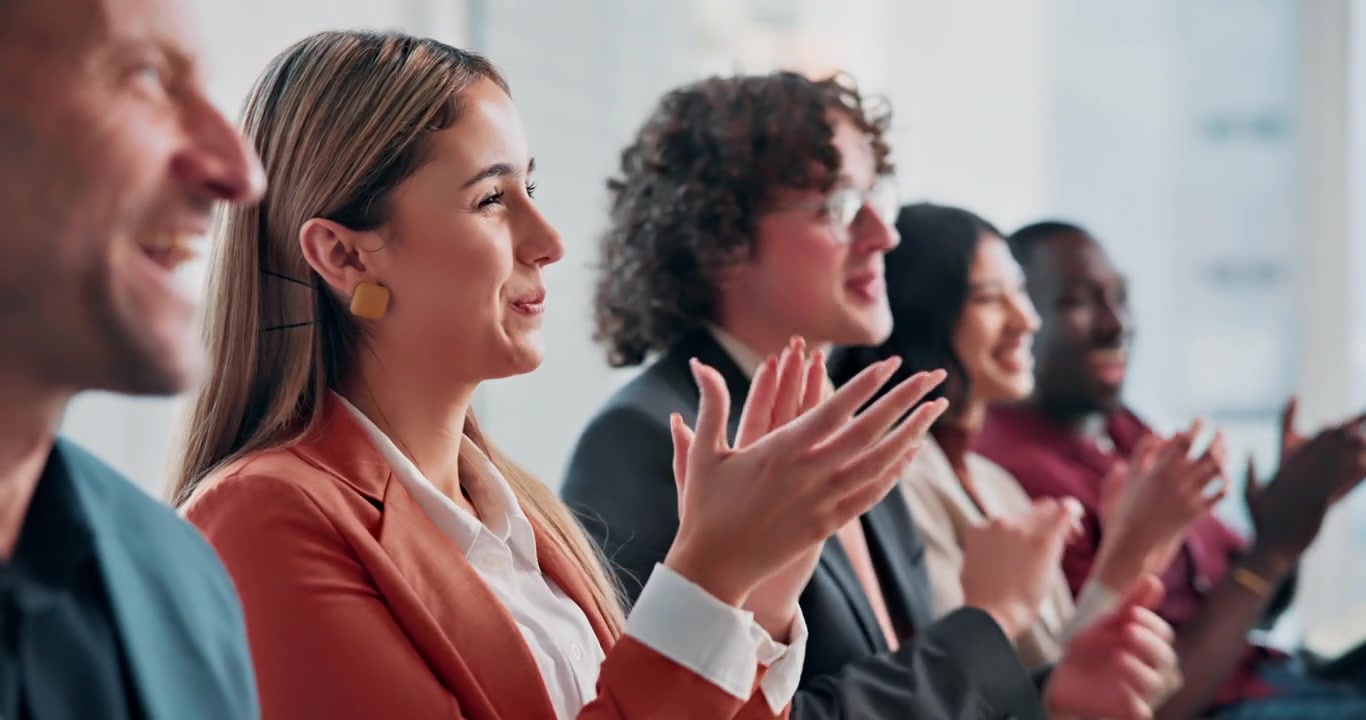 Diverse Group of Professionals Applauding During a Business Conference
