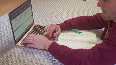 a university student works rapidly on his laptop to finish his project before class starts