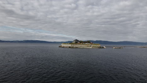 The-Island-Munkholmen-Located-In-Trondheim-Fjord-Near-The-Norwegian-City-Trondheim---aerial-drone-shot