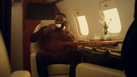 African-american-talking-smartphone-on-business-travel.-Joyful-man-enjoying-trip