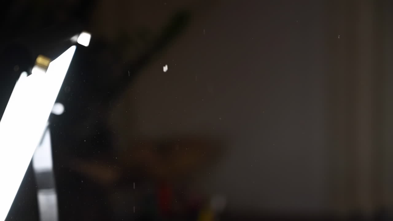 Close up of dust particles flying in the air near a light