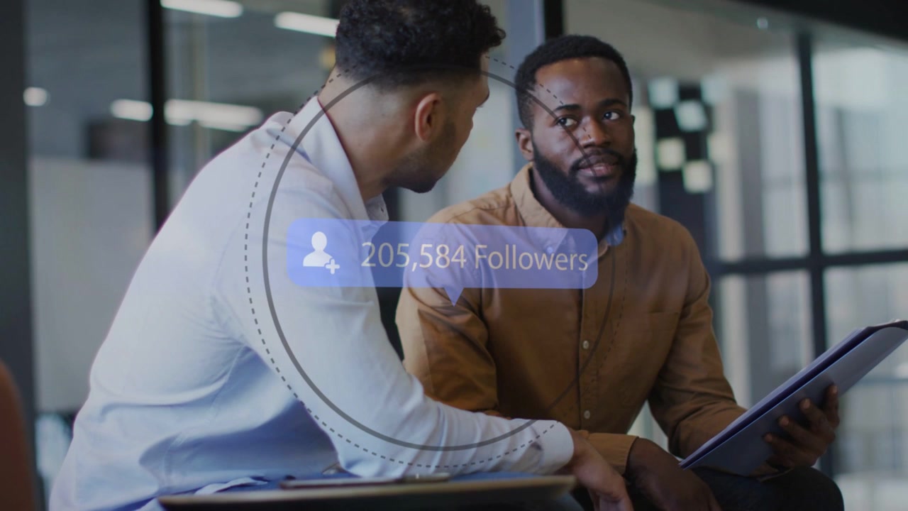 Two men talking in marketing office, talk starting, HUD appearing above tablet, tracking followers