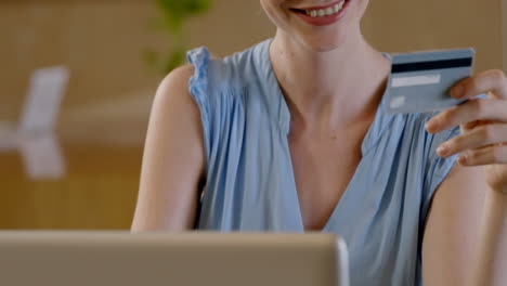 Casual-businesswoman-with-credit-card-and-laptop