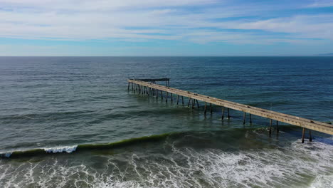 aerial tilt shot rising over the pacifica municipal pier in sunny california, usa