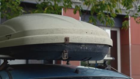 car roof box on a blue sedan