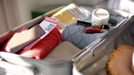 A suitcase displays neatly packed travel essentials