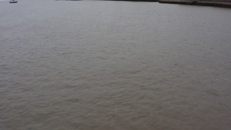 drone shot rising over river mersey