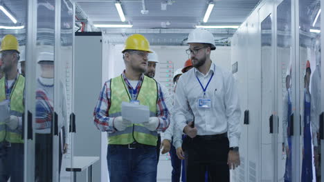 engineers reviewing documents in a server room