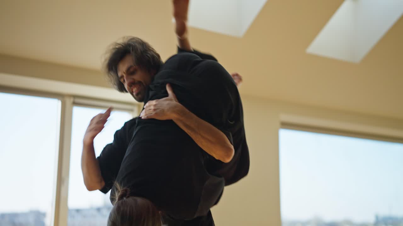Dancers performing in a studio with a cityscape background
