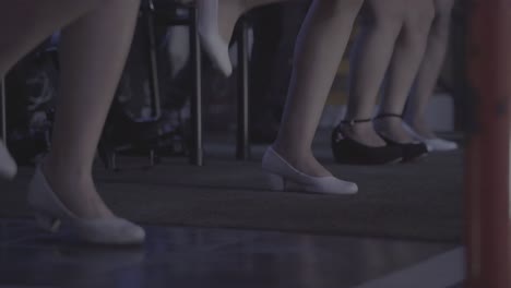 Close-up-shot-showing-group-of-dancing-women-with-white-shoes---South-American-folklore-Dance-on-stage---low-angle