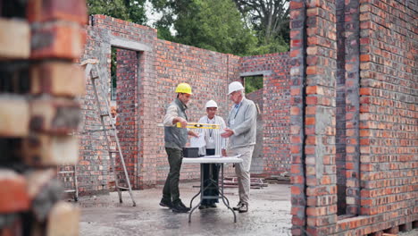 construction workers planning at a bricklaying site