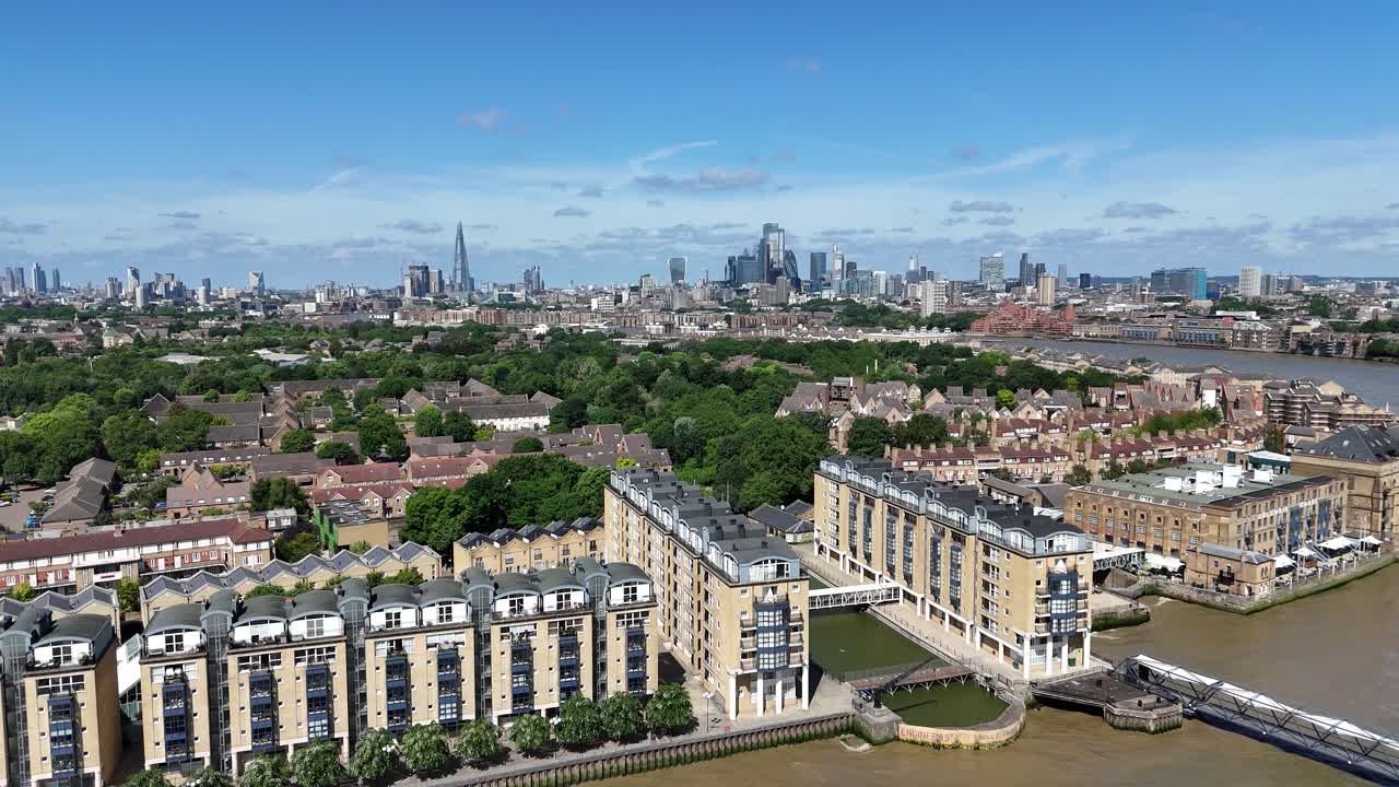 Aerial descent towards historic Nelson Docks in Rotherhithe, London, revealing rich maritime heritage along the River Thames with striking views of old and modern contrasts.