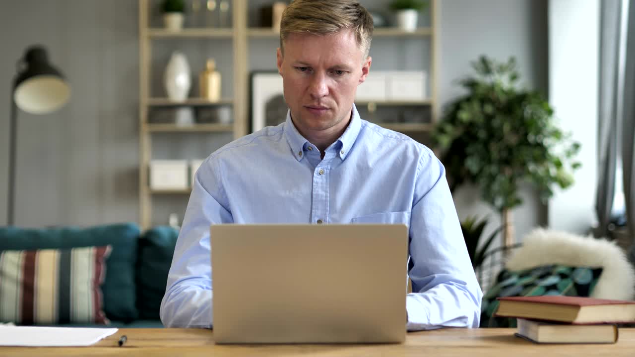 Businessman Working On Laptop in Office