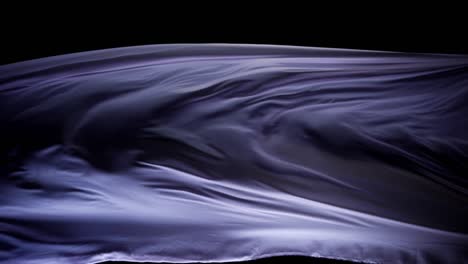 beautiful purple silk floating in black background -close up