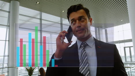 animation of multicolored bar graphs over caucasian man talking on smartphone in office