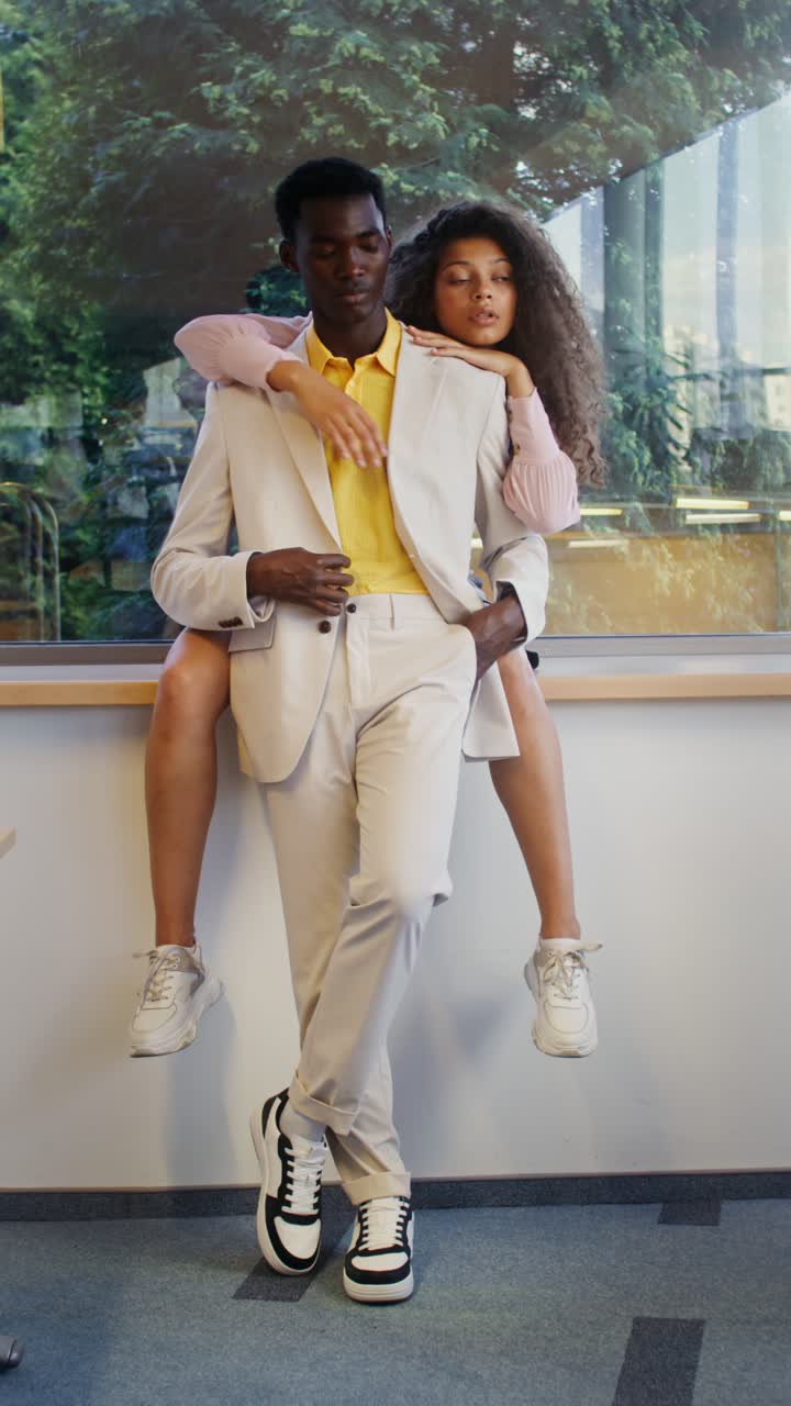 Couple piggybacking indoors