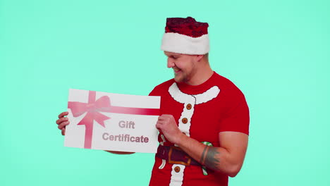 Funny-man-wears-red-New-Year-t-shirt-and-hat-presenting-card-gift-certificate-coupon-winner-voucher