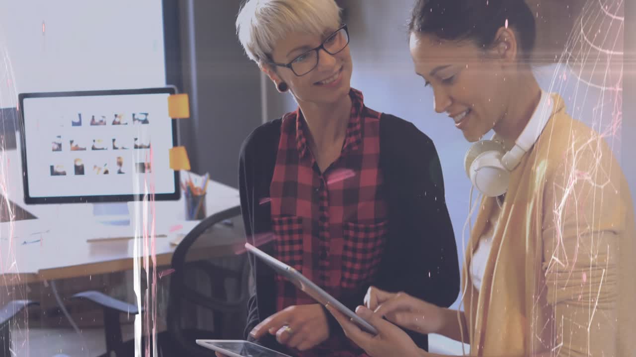 Animation of icons and data processing over diverse business people using tablet