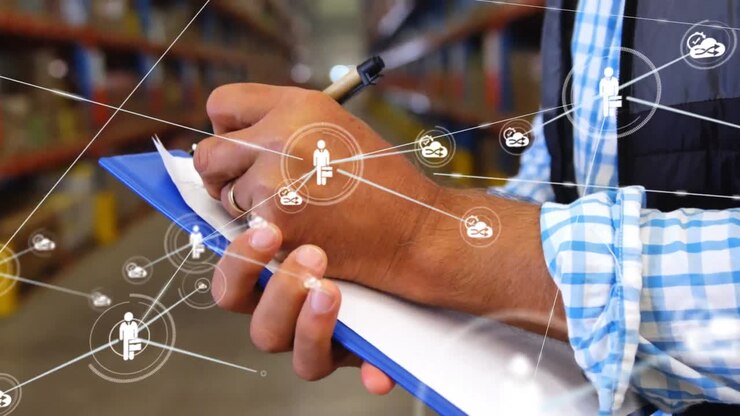 Animation of network of connections with icons over man making notes in warehouse