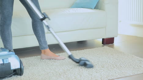 video of woman hoovering rug