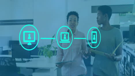 Animation of network of connections with icons over diverse colleagues discussing work in office