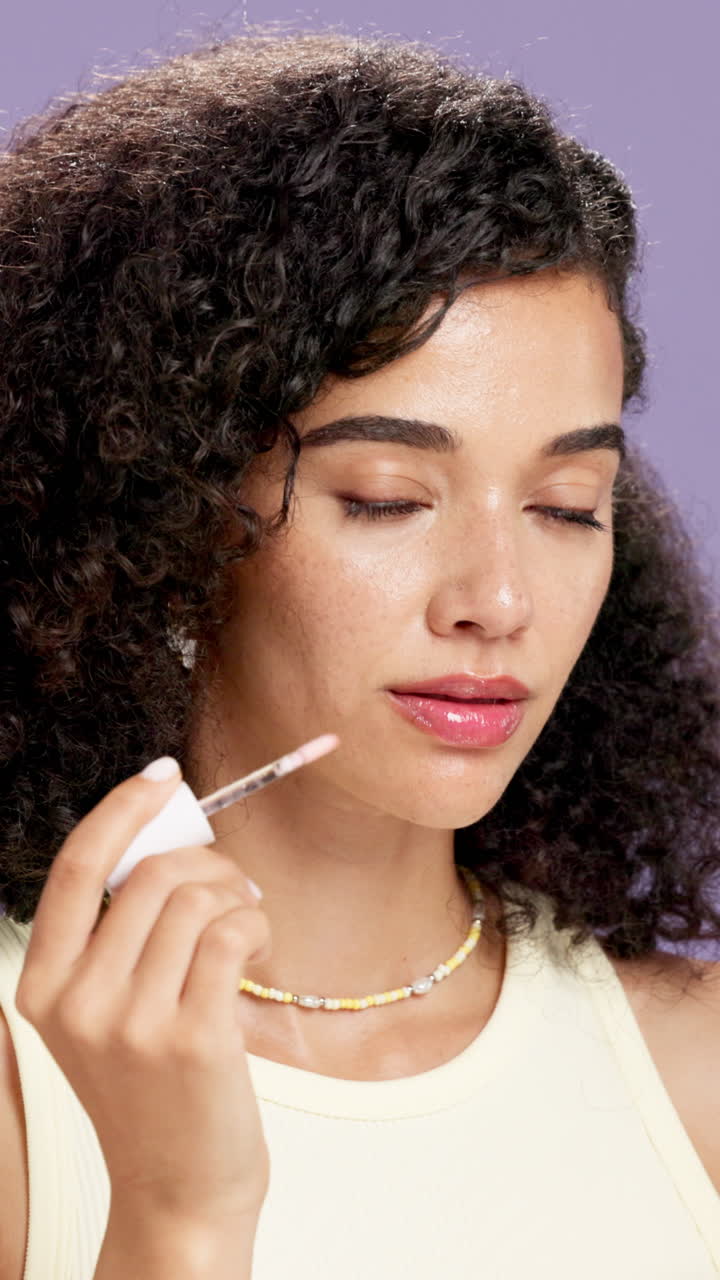 Woman applying lip gloss