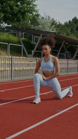 woman stretching on a track