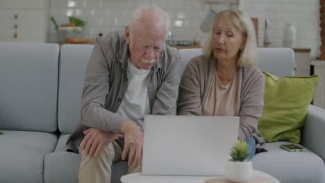 older couple using laptop together at home