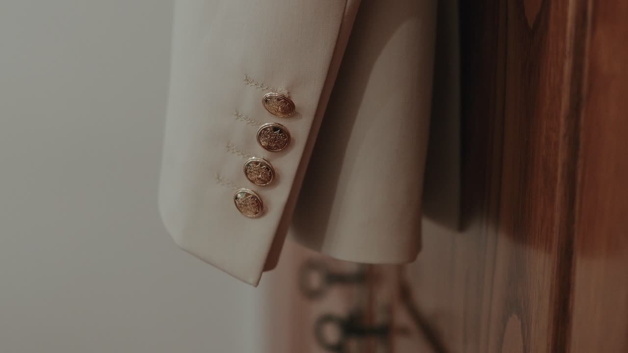 Detail of formal suit jacket sleeve with decorative buttons