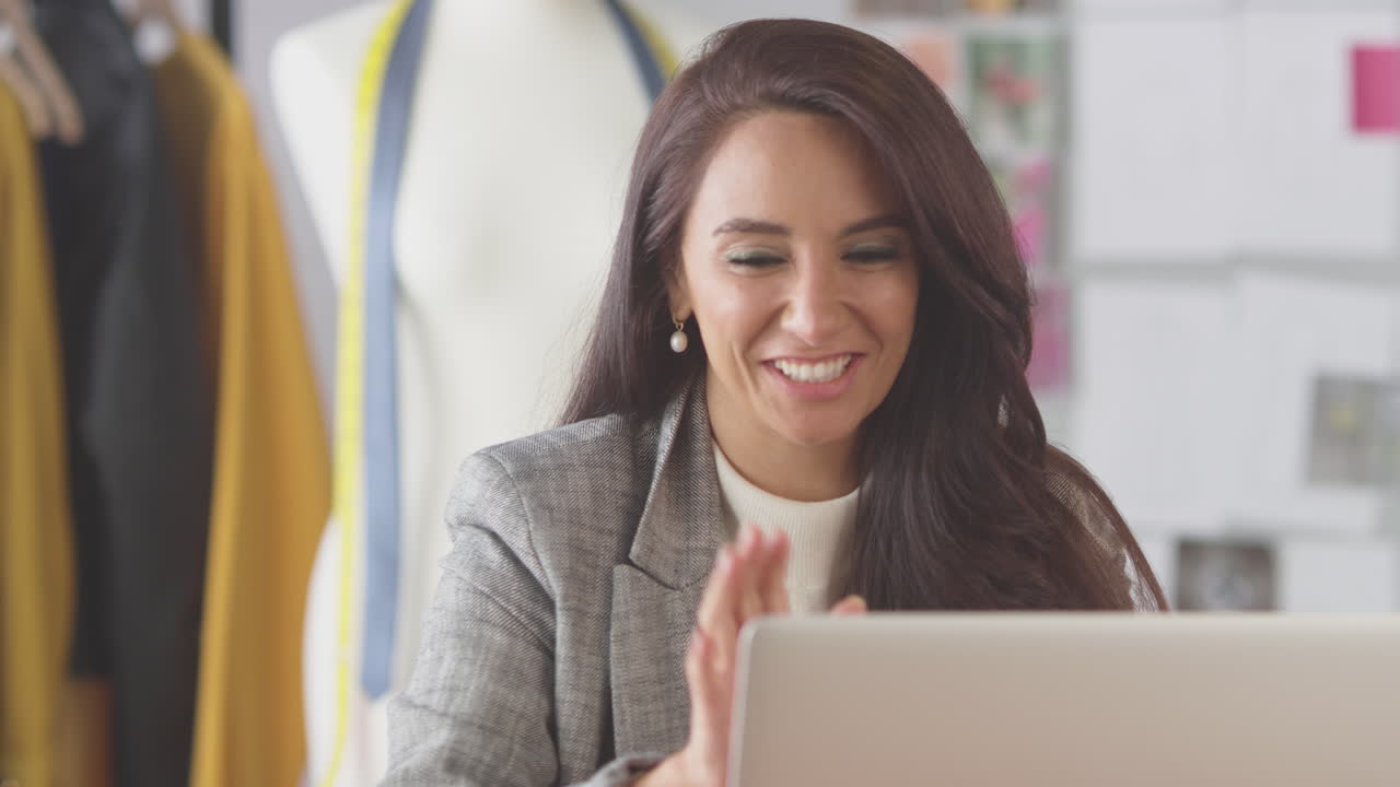 Female Fashion Designer In Studio Making Video Call At Desk On Laptop ...