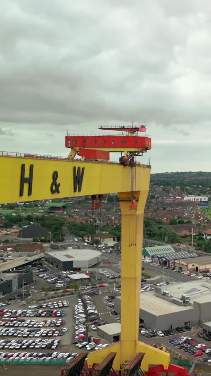 Side-on, close-up social ratio aerial video of the Harland and Wolff cranes in Belfast, Northern Ireland, UK. Produced in 1080x1920, 60FPS and with Rec709 color